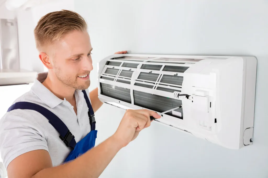 Experienced AC repair specialist diagnosing cooling system issues
