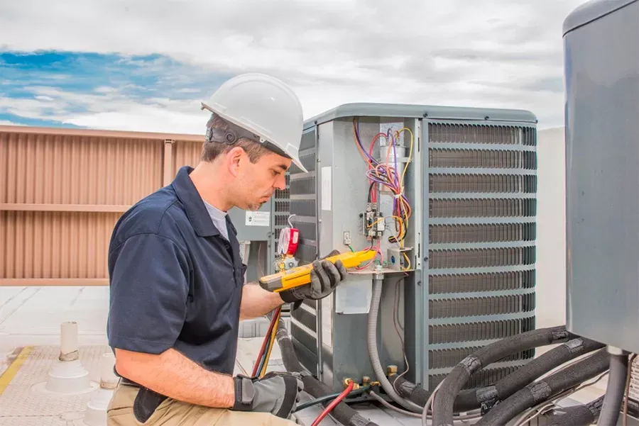 Air conditioning unit receiving professional maintenance and cleaning service