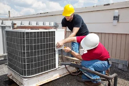 Technician installing new air conditioning system in home